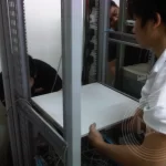 Three IT technician is installing the server rack