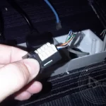 A hand holding a plug