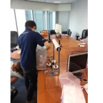 The IT technician is packing a CPU and other office appliances for office relocation