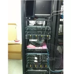 A computer with wires in a server room