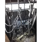An image of unorganized cables in a server room