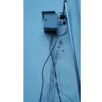 A box with wires on the side of a wall