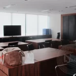 A bag on a table with the background of office setting