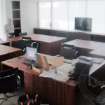 An old man in an office with some office appliances packed for relocation