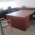 Two desks and three chairs in an office