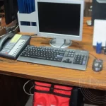 A desk with a computer and a keyboard