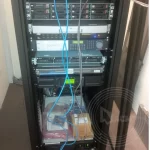 A computer server with two wires hanging in front of the rack