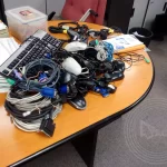 a group of computer cables and cords on a table