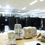 A room full of computer servers and computer hardware that have not been unboxed