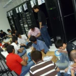 A group of IT technicians unboxing the fiber cabling in a server room