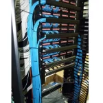 A close-up of a server with blue vertical cable fibre routing